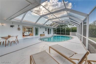 Outdoor pool featuring glass enclosure and a patio