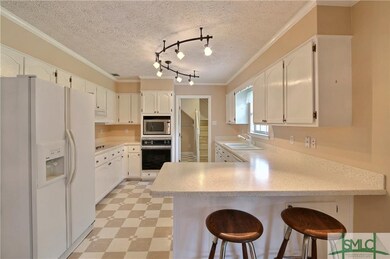 Open and bright kitchen with solid surface counter