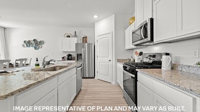 Kitchen featuring white cabinets, stainless steel 