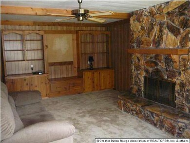 Large living room with stone fireplace and built-i