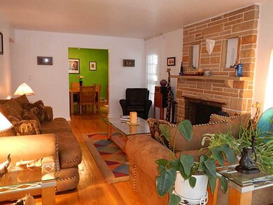 Living Room. Hardwood Floors in this LivingRoom . Fllor to Ceiling Stone Fireplace  Nice Touch.