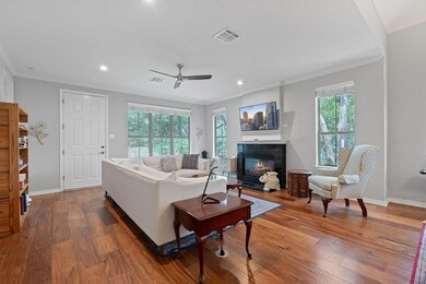 Living area with a tile fireplace, plenty of natu