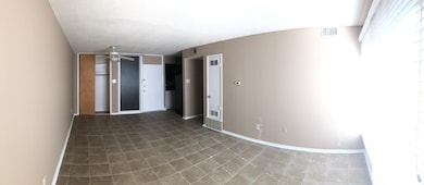 Unfurnished room with baseboards and a ceiling fan