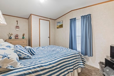 Bedroom featuring ornamental molding and vaulted c
