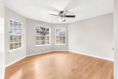 Unfurnished room with ceiling fan, a textured ceil