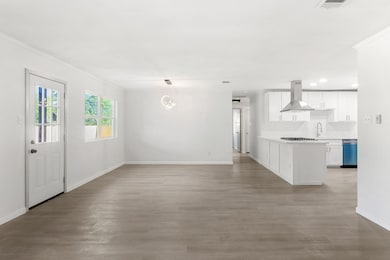 Unfurnished living room featuring crown molding, 