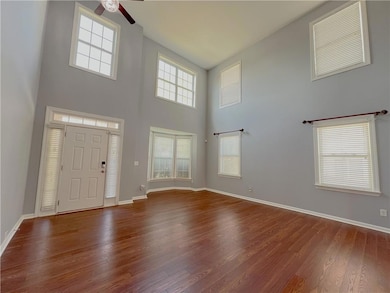 Entrance foyer featuring a ceiling fan, a towering