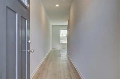 Corridor featuring light wood-type flooring