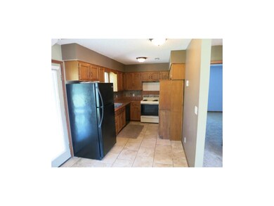 Kitchen with tile flooring and concrete counter to