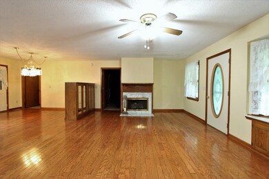 Super open floorplan, broken up by a moveable china cabinet. Great hardwood floors! Wood burning fireplace currently being used with gas logs