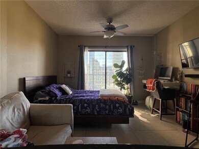 Bedroom featuring ceiling fan, light tile patterne