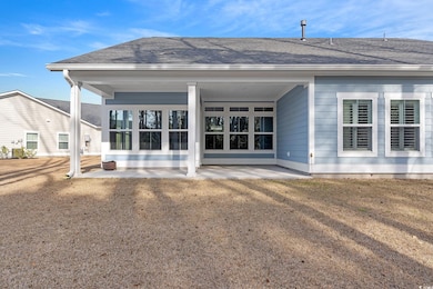 Back of property featuring a shingled roof and a p