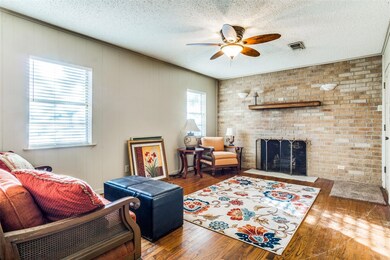 Living room featuring a brick fireplace, a texture