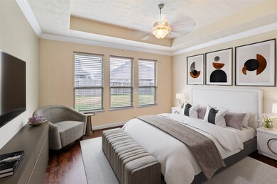 What a wonderful place to come home to, this stunning master suite greets you with gorgeous floors, a warm custom paint, high ceiling, crown molding, ceiling fan with lighting, and large windows with blinds allowing in natural light brightening up this spacious master bedroom.