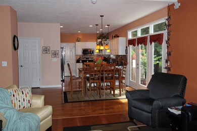The spacious great room features a fireplace, vaul