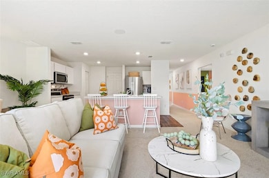 Living room with light carpet and recessed lightin