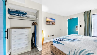 Bedroom featuring wood finished floors and baseboards