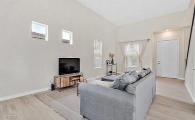 Living room with light wood-style flooring and bas