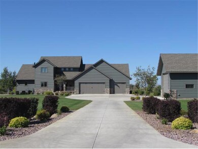 Front of house with large concrete driveway, profe