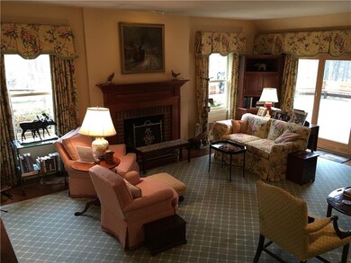 Large living room has hardwood flooring and slidin