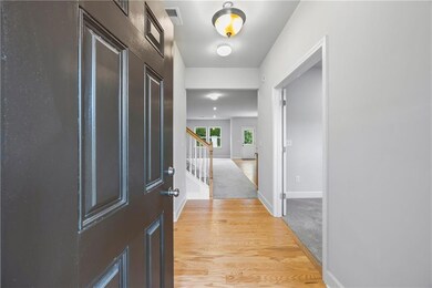 Foyer featuring baseboards and stairway