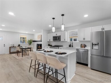 Kitchen featuring a center island, a sink, a wealt
