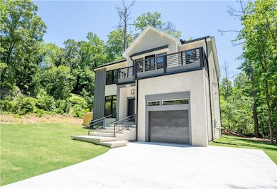 Modern home with a balcony, concrete driveway, an attached garage, a front lawn, and board and batten siding