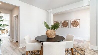 Dining room with light wood-style flooring and baseboards