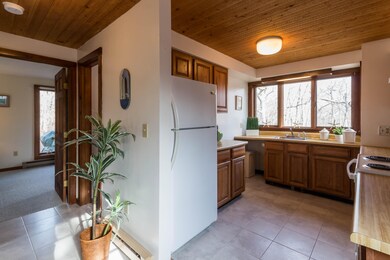Kitchen overlooks wooded common land
