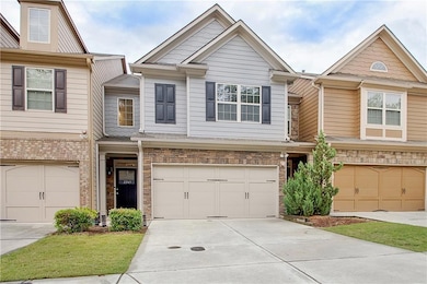 View of property with an attached garage and concr