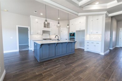Kitchen with decorative light fixtures, oven, a ce