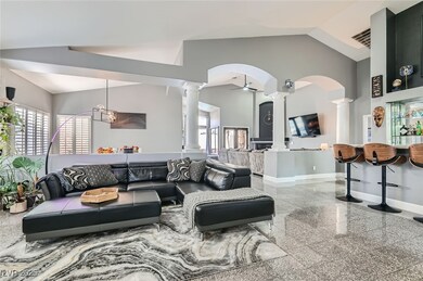 Living area featuring baseboards, granite finish f