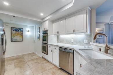 Kitchen featuring baseboards, stainless steel appl