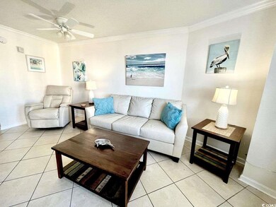 Living room with light tile patterned floors, a te