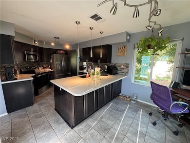 Kitchen featuring a decorative backsplash, light t