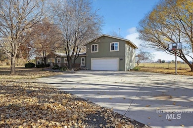 View of front of property with driveway and a garage