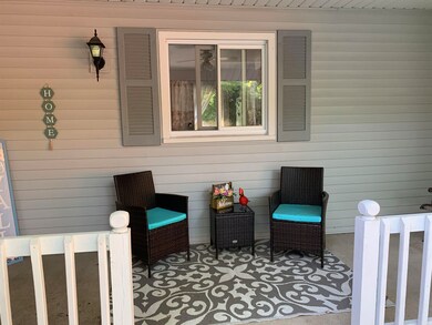 Plenty of space for outdoor furniture on the porch.  This home gives you the option to enjoy the front yard view and visiting with neighbors as the wall by or you can enjoy the backyard with its trees and peaceful feel.