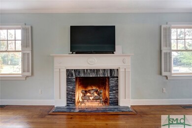 Home features plantation shutters and hardwood flo