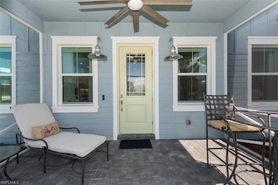 Property entrance featuring ceiling fan and a porc