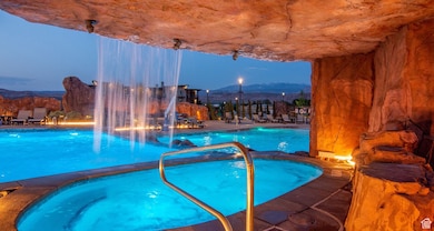 Community pool with a hot tub, a patio area, and a mountain view