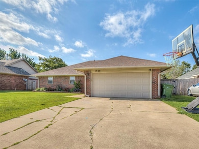 Ranch-style home featuring a garage and a front la