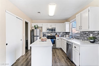 Kitchen featuring a sink, tasteful backsplash, app