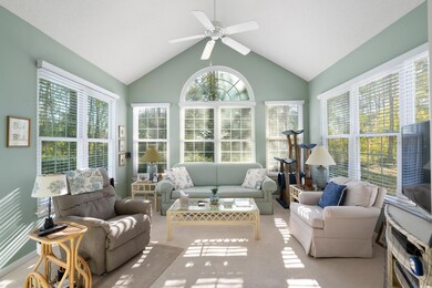 Sunroom / solarium featuring ceiling fan and vault