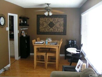 Dining area features laminate wood floor, fresh pa