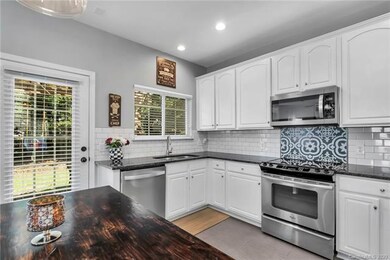 Kitchen opens to outdoor pergola covered patio.