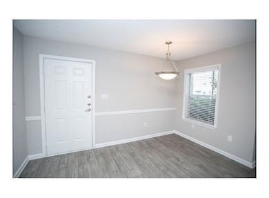Empty room featuring dark hardwood / wood-style fl