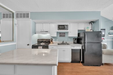 White cabinetry and light countertops really gives