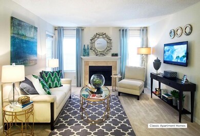 Living room with carpet, a tile fireplace, and a textured ceiling