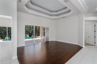 Living room with a raised ceiling, a towering ceil