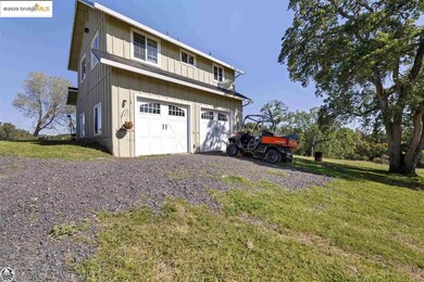 Garage featuring a lawn